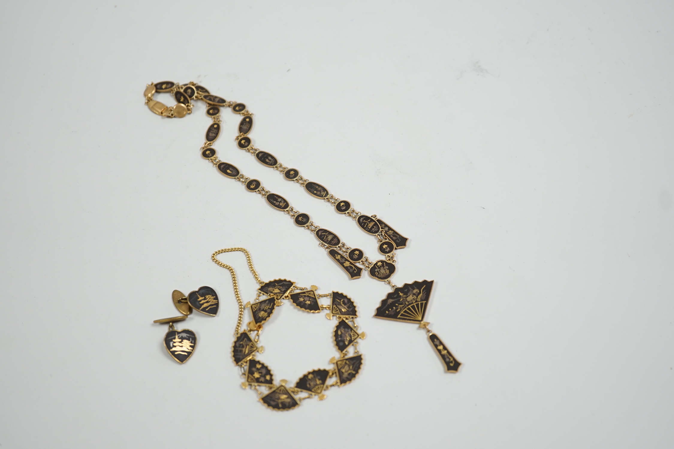 A Japanese gilt damascened iron work suite of jewellery: necklace, bracelet and a pair of cuff links